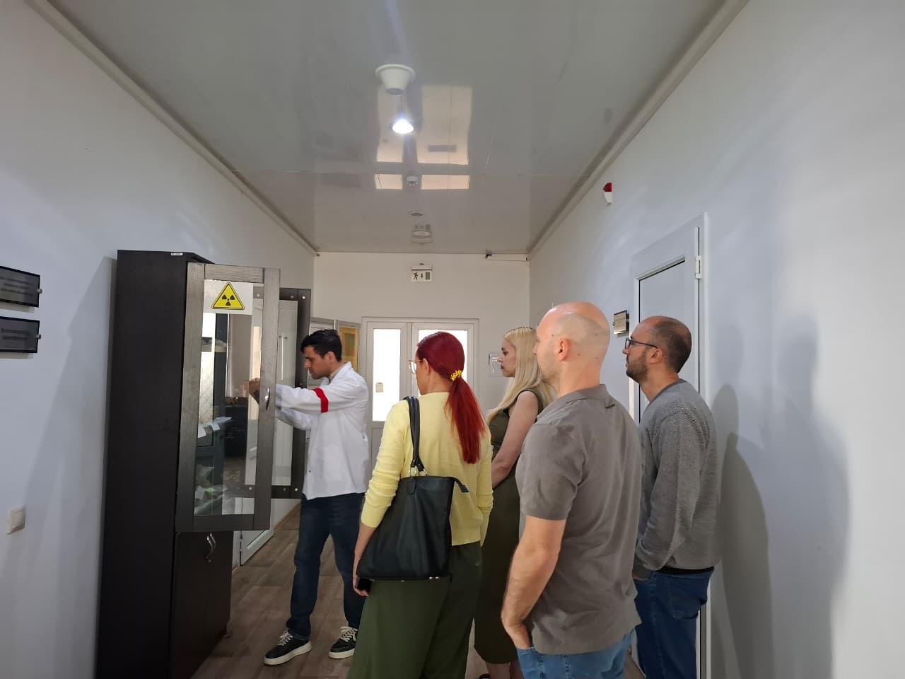 AGU team visiting a radiation monitoring area with a SETM representative