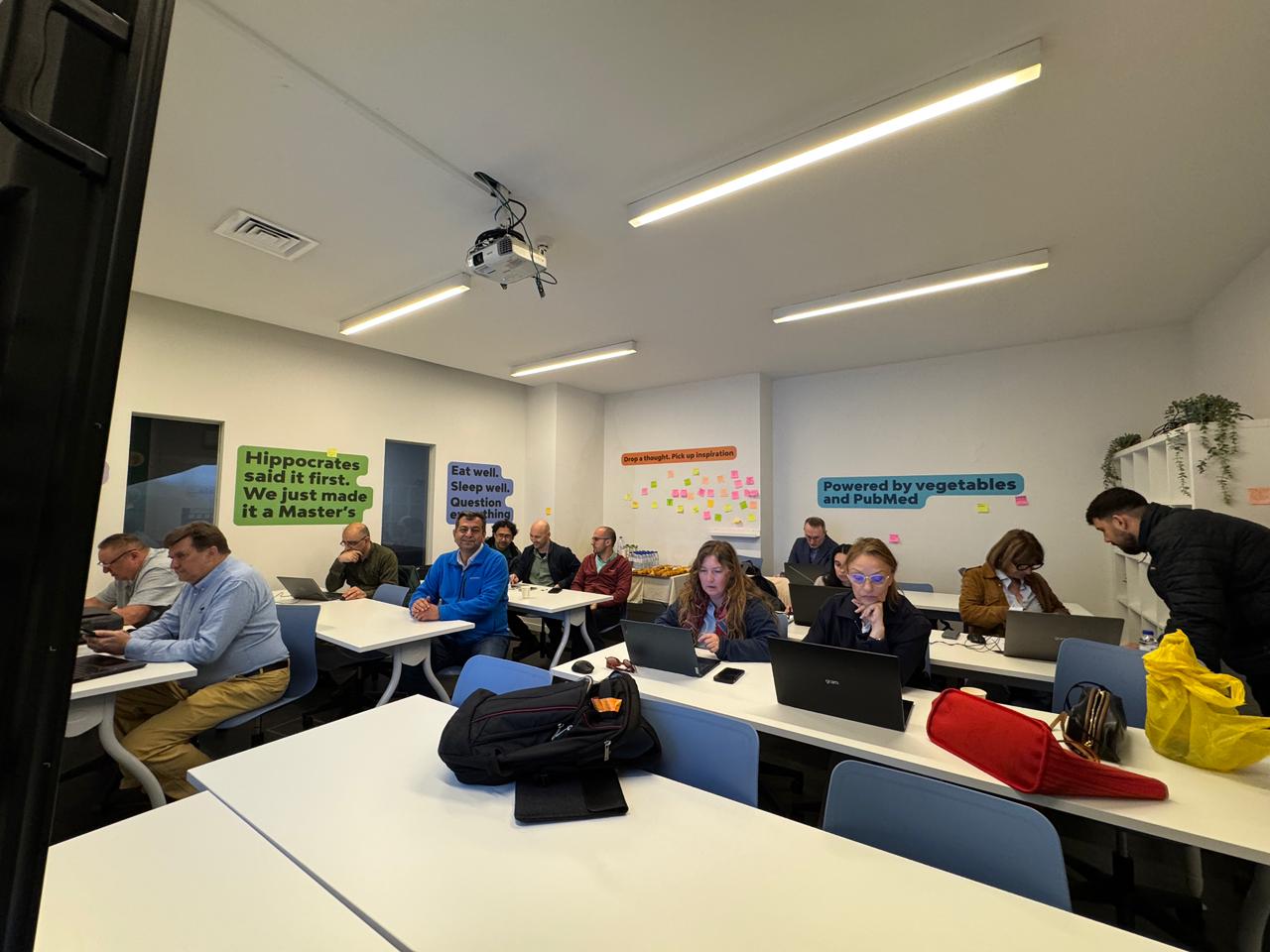 Kick-off meeting discussion with participants around classroom desks