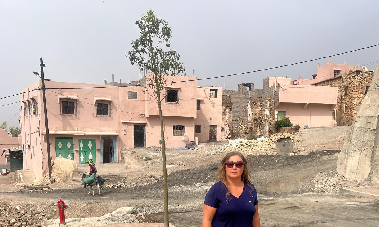 Prof. Nazire Nergiz Dinçer during the field visit, with buildings and a street in Moulay Brahim behind her