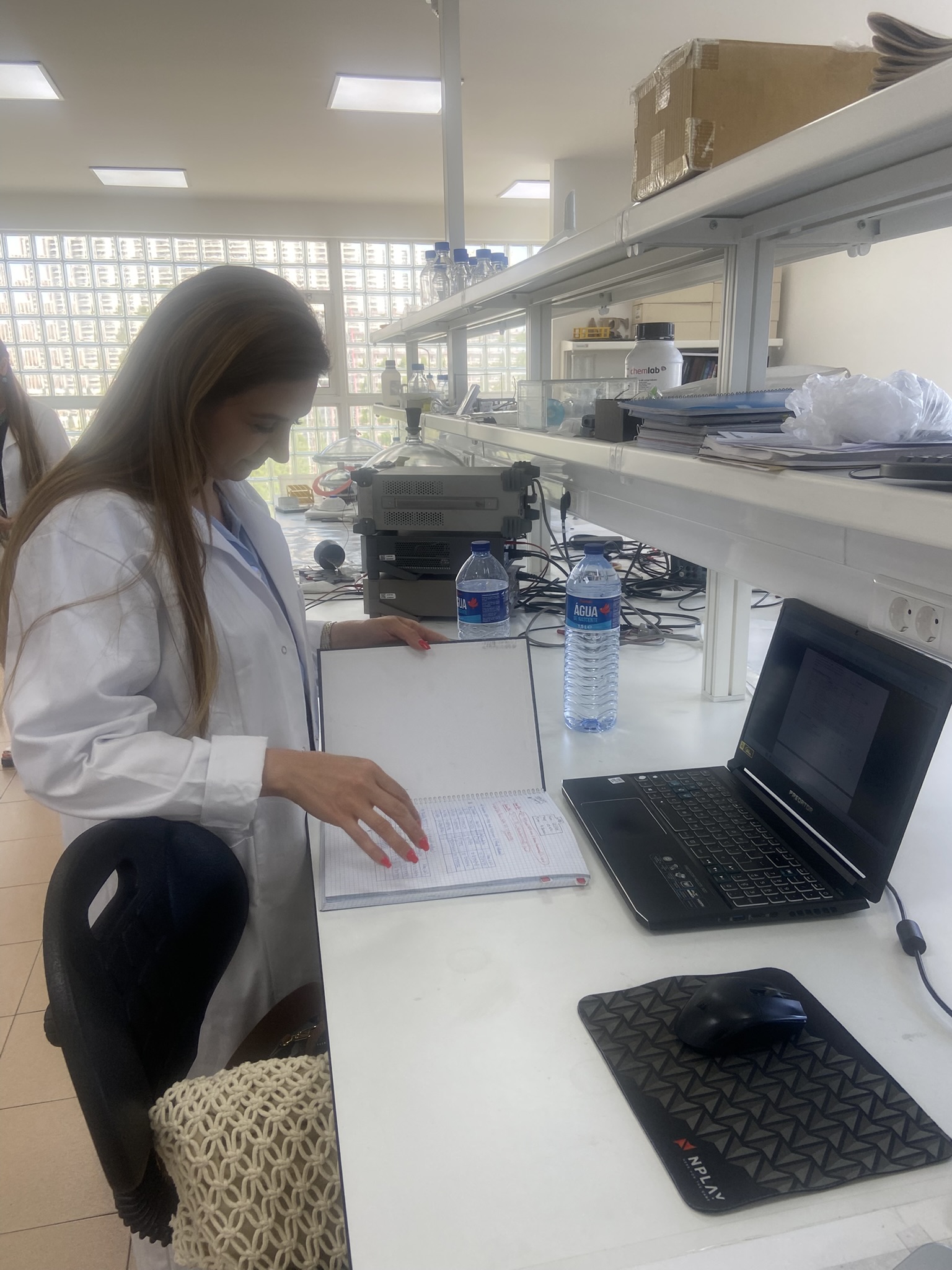 SETM researcher reviewing laboratory notes during secondment activities